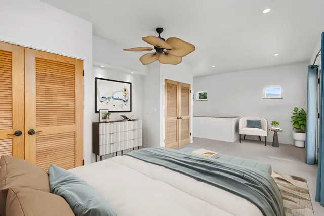 a bedroom with a balcony a bed and a window