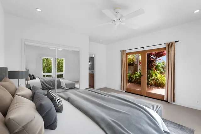 a front view of house with yard and trees in the background