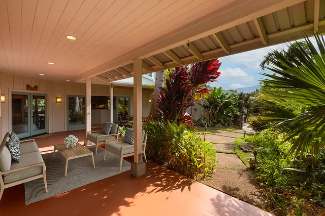 a view of a patio with table and chairs and potted plants