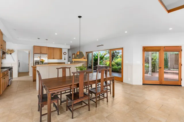 a dining room with furniture and a large window