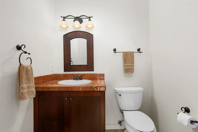 a bathroom with a toilet sink and mirror