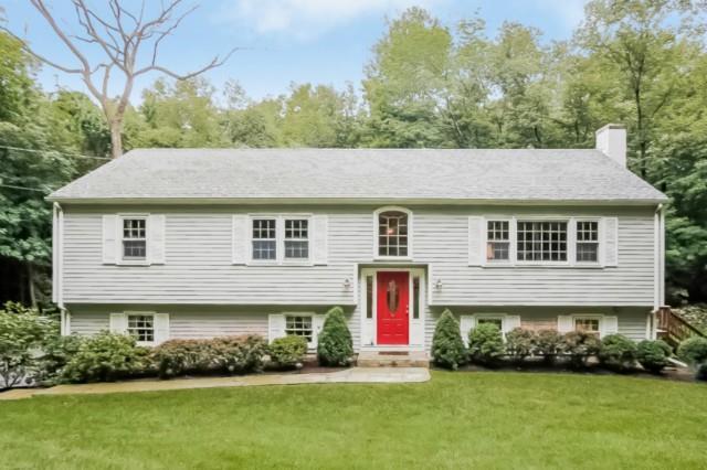 91 Pipers Hill Road Wilton, CT 06897 - Photo 1 of 1 a aerial view of a house with a yard and potted plants