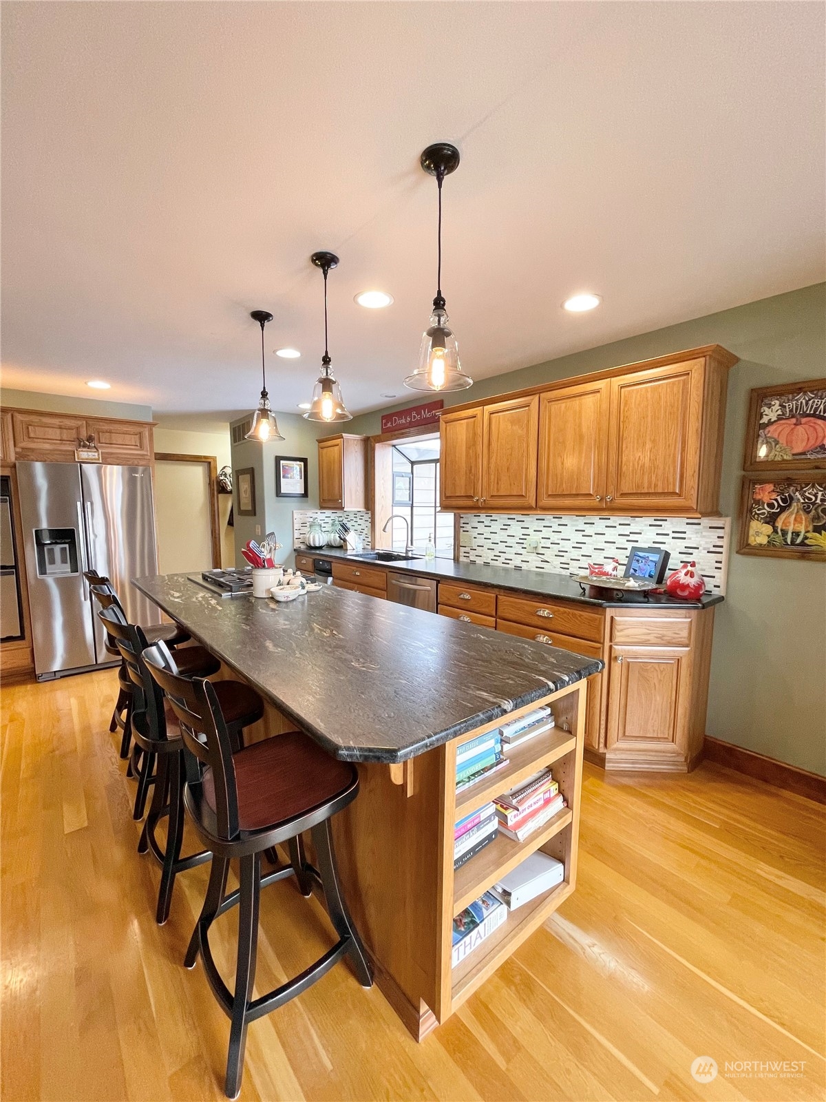 14 Pogue Road Okanogan, WA 98840 - Photo 12 of 40 a kitchen with stainless steel appliances granite countertop a stove a sink dishwasher and a dining table with wooden floor