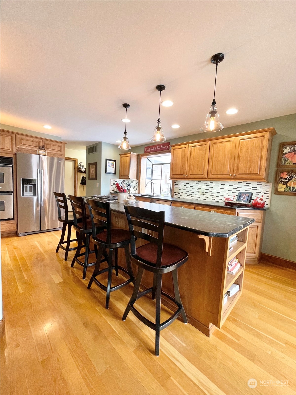 14 Pogue Road Okanogan, WA 98840 - Photo 20 of 40 a kitchen with stainless steel appliances granite countertop a stove top oven a sink a dining table and chairs with wooden floor
