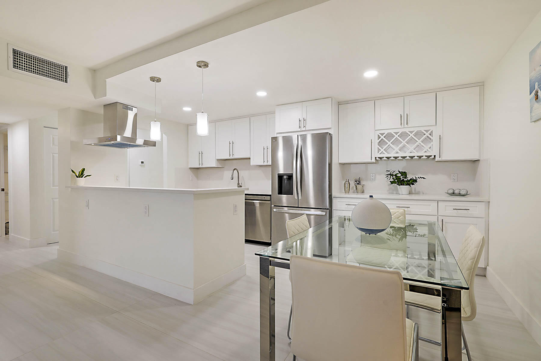2121 North Ocean Boulevard, Unit 806W Boca Raton, FL 33431 - Photo 10 of 63 a kitchen with stainless steel appliances a refrigerator sink and microwave