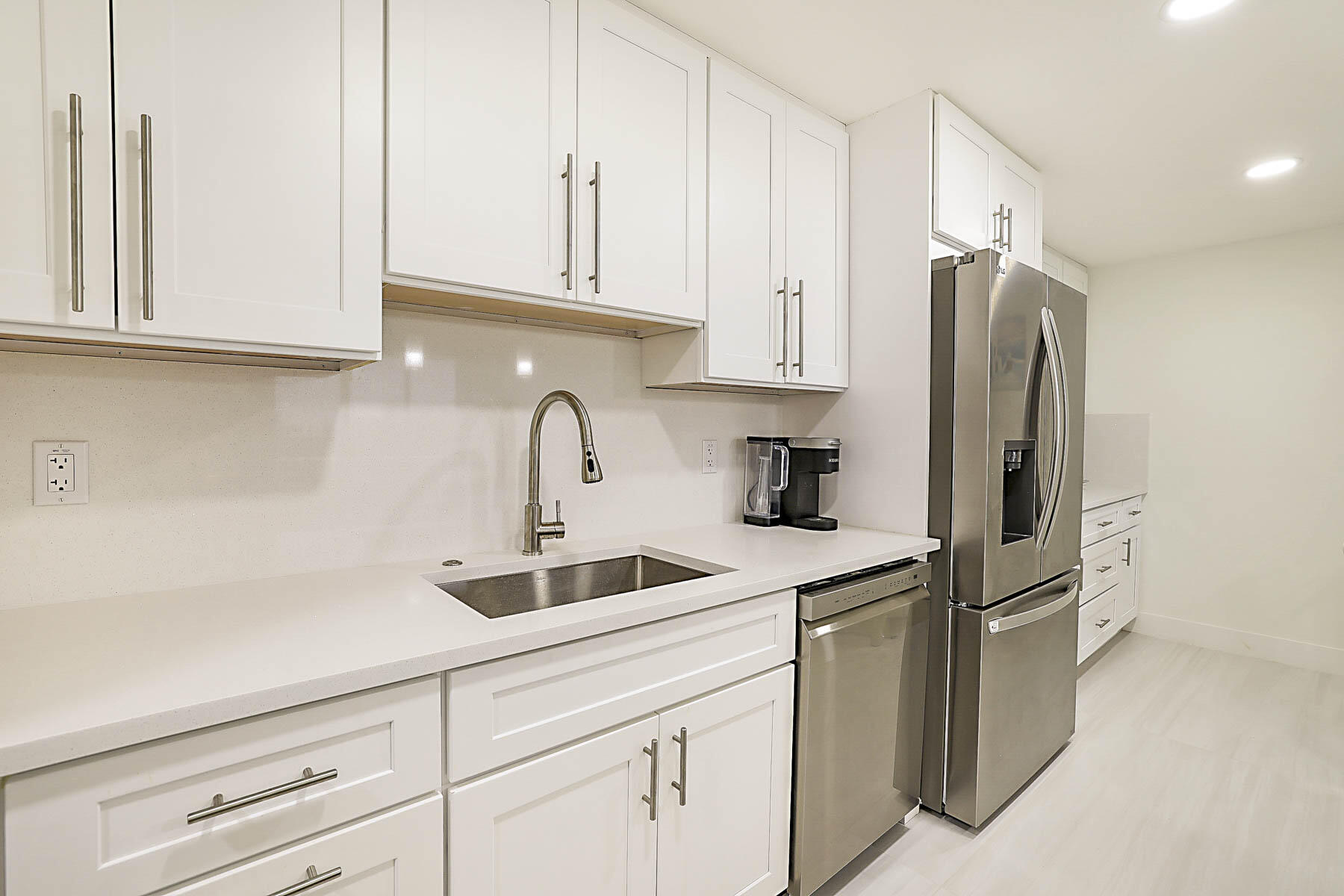 2121 North Ocean Boulevard, Unit 806W Boca Raton, FL 33431 - Photo 17 of 63 a kitchen with stainless steel appliances granite countertop a refrigerator sink and cabinets
