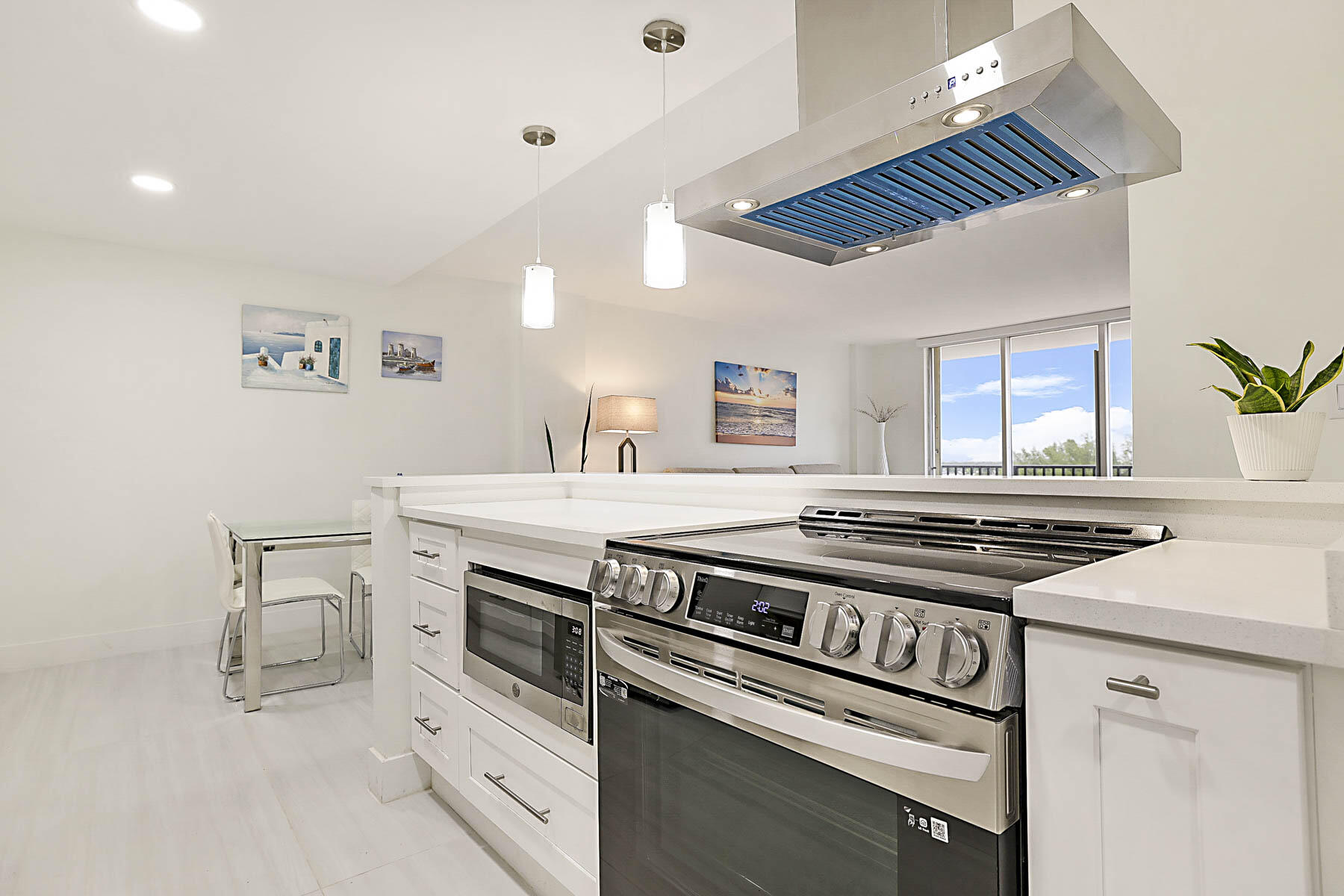 2121 North Ocean Boulevard, Unit 806W Boca Raton, FL 33431 - Photo 18 of 63 a kitchen with a stove and a sink