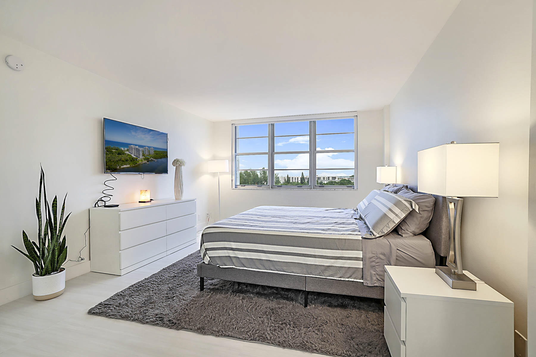 2121 North Ocean Boulevard, Unit 806W Boca Raton, FL 33431 - Photo 20 of 63 a bedroom with a bed and a flat screen television