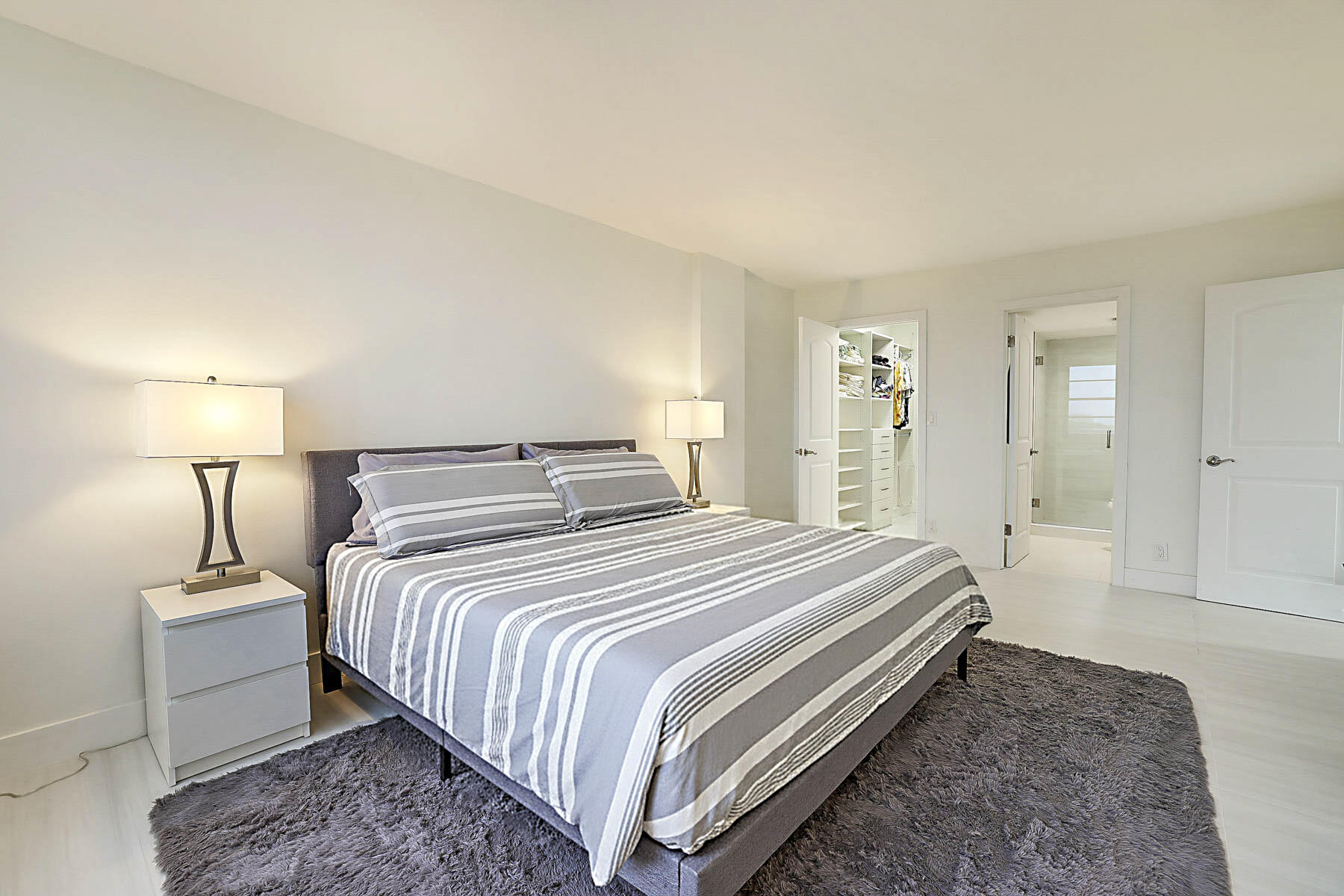 2121 North Ocean Boulevard, Unit 806W Boca Raton, FL 33431 - Photo 23 of 63 a bedroom with a bed and a lamp