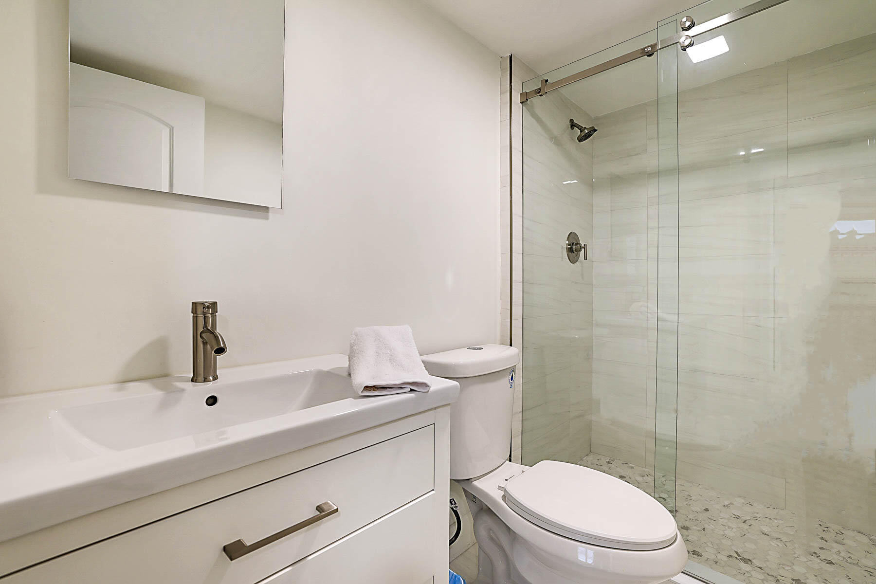 2121 North Ocean Boulevard, Unit 806W Boca Raton, FL 33431 - Photo 31 of 63 a bathroom with a sink a toilet and shower