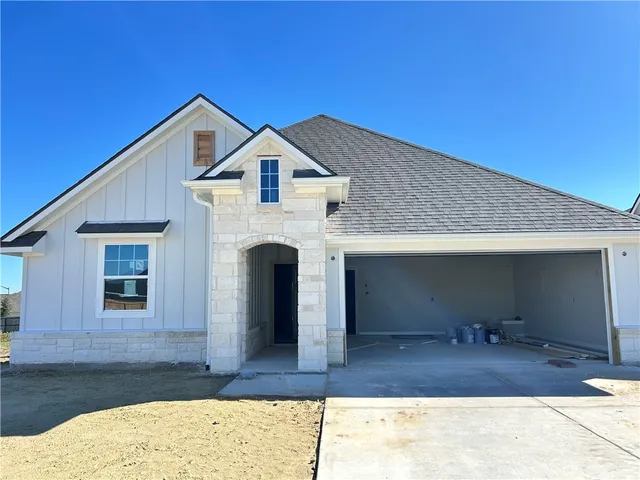 a front view of a house with garage