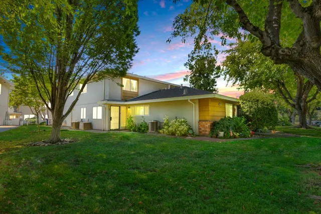 a view of a yard with a house in the background