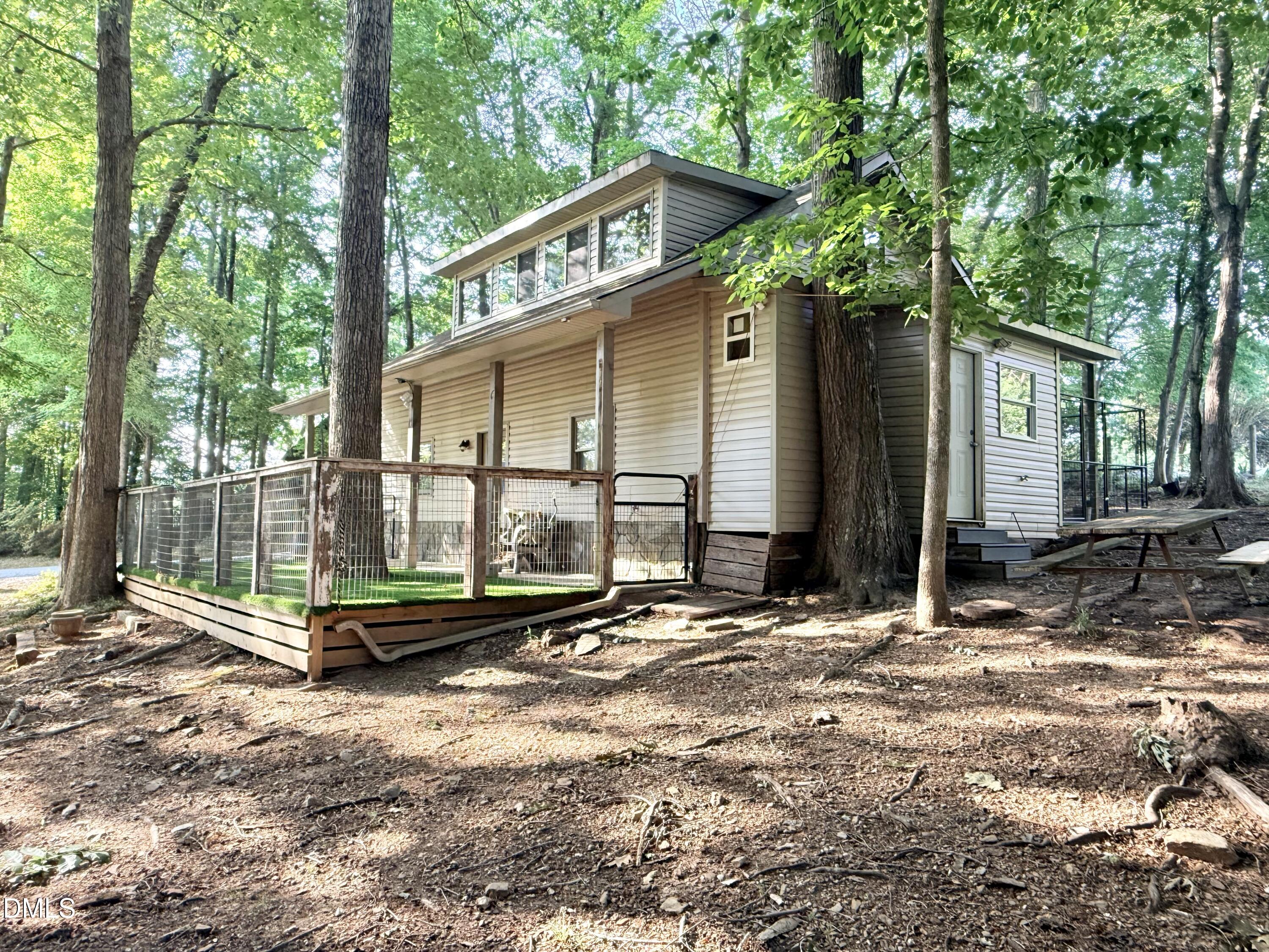 81 Beaver Crossing Road Roxboro, NC 27574 - Photo 59 of 80 a backyard of a house with wooden floor and fence