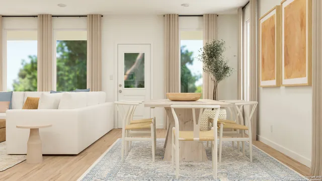 a view of a dining room with furniture and a window