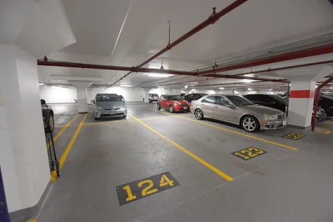 a view of parking garage with cars parked
