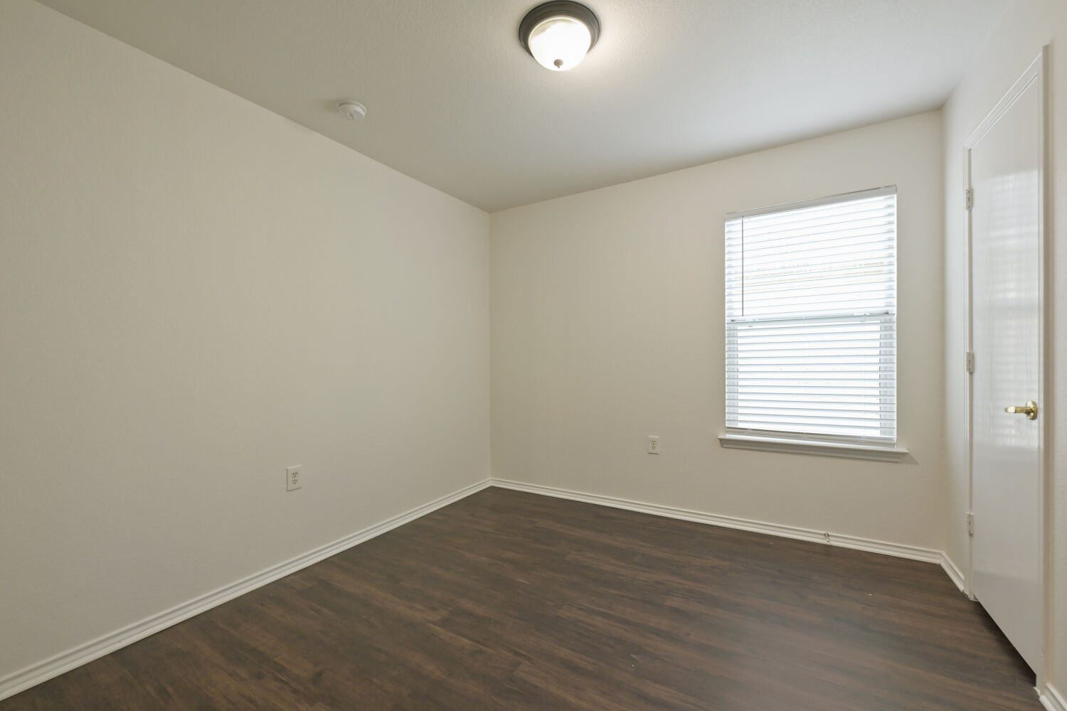 6733 Doyal Drive Austin, TX 78747 - Photo 12 of 28 Laminate flooring and a bright window create an inviting atmosphere in this versatile living area.
