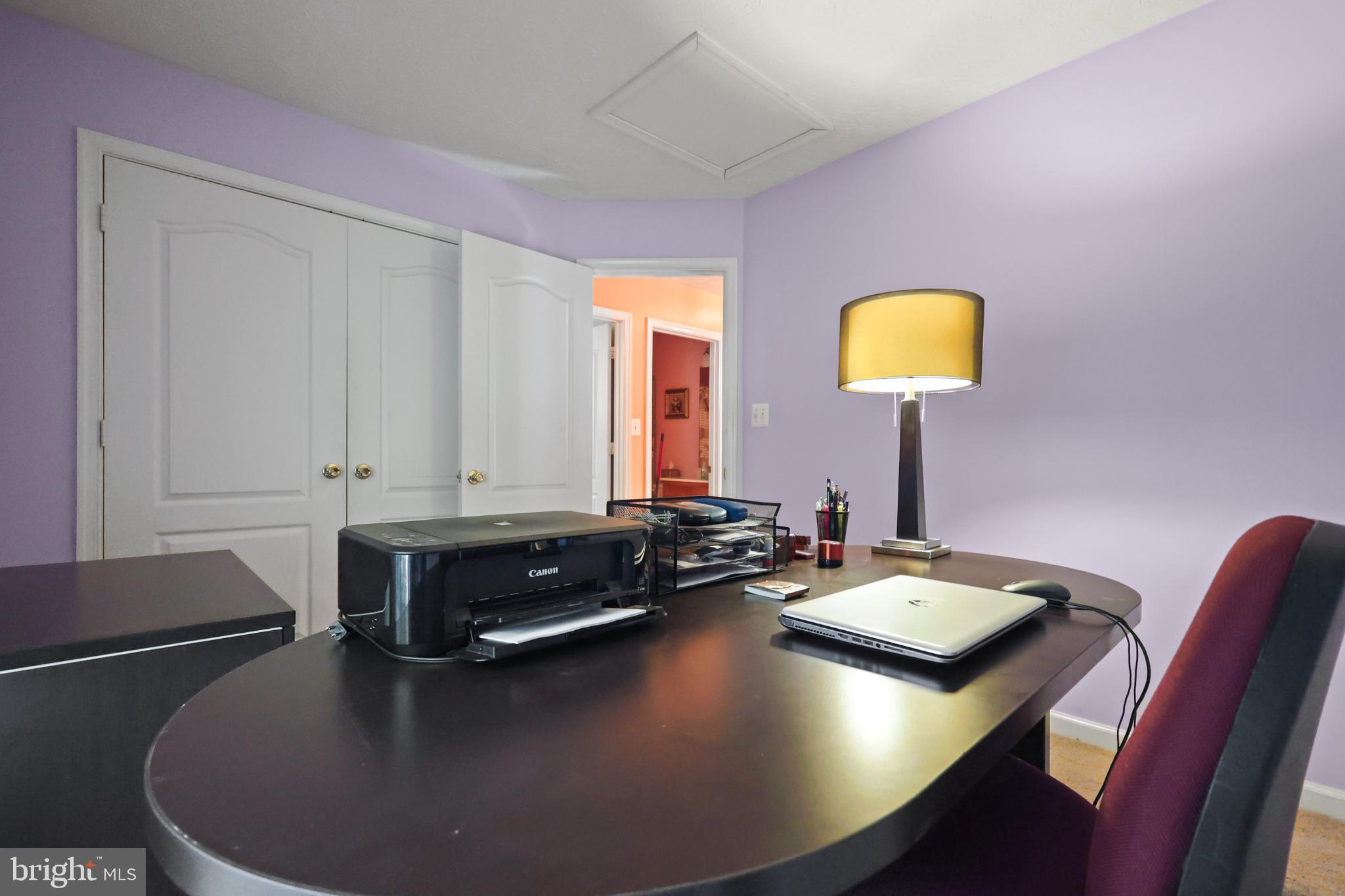 9716 Penguin Place Upper Marlboro, MD 20772 - Photo 15 of 84 a view of a workspace with a table and couch