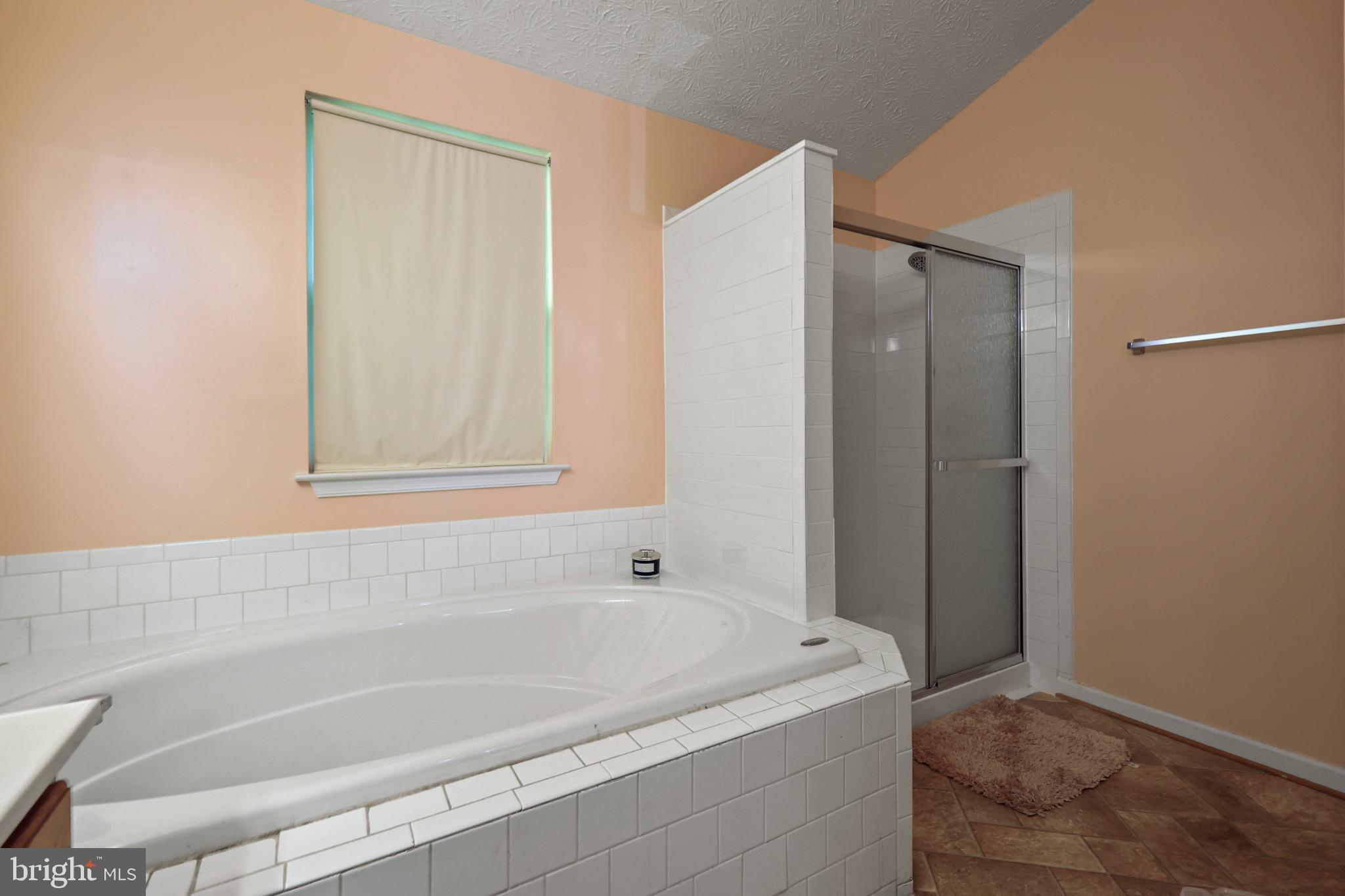 9716 Penguin Place Upper Marlboro, MD 20772 - Photo 16 of 84 a bathroom with a tub and shower