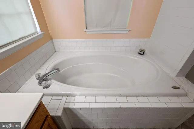 a view of staircase with railing and white walls