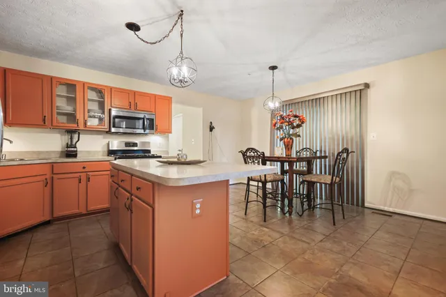 a kitchen with cabinets a sink and appliances