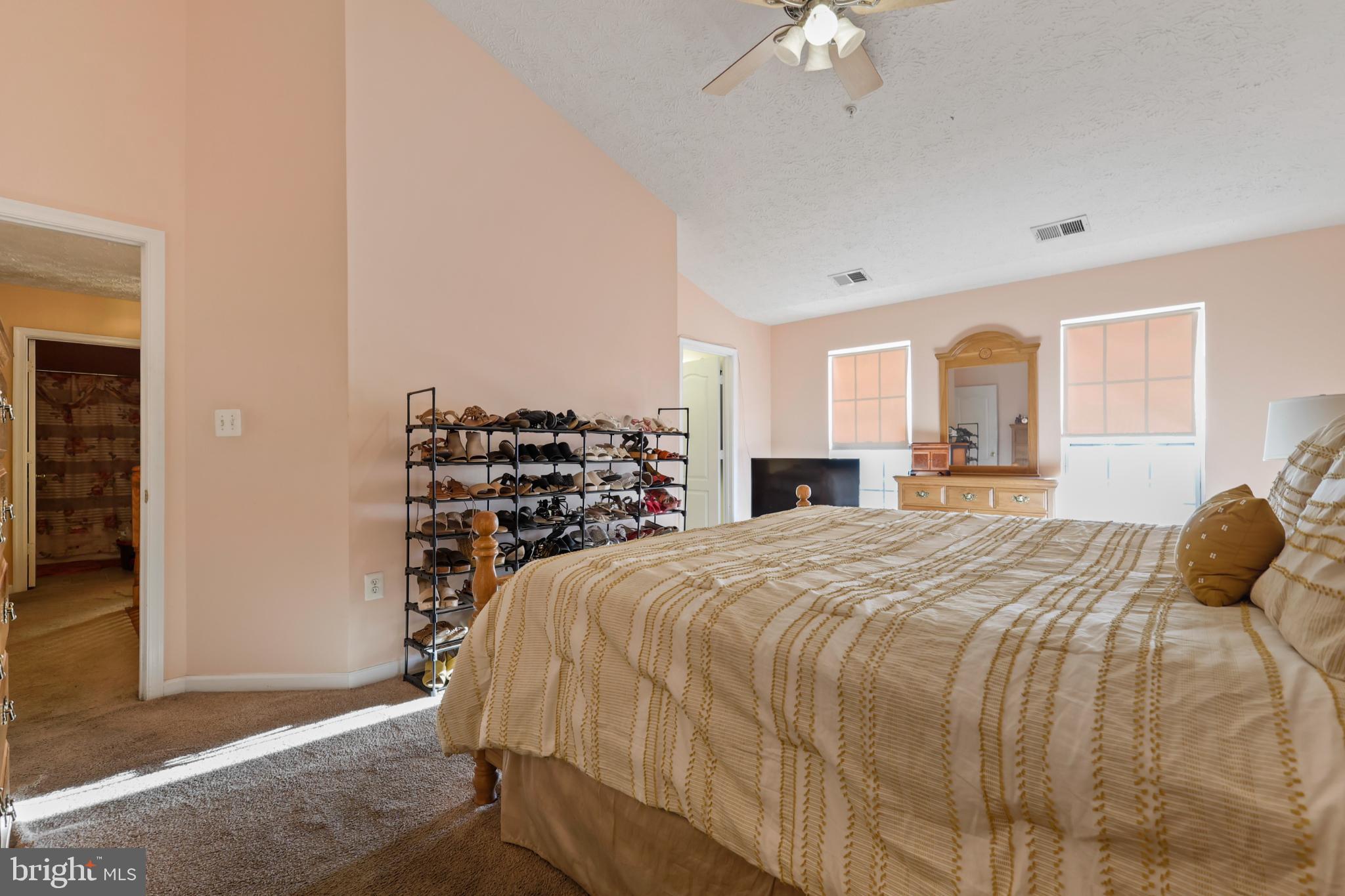 9716 Penguin Place Upper Marlboro, MD 20772 - Photo 21 of 84 a bedroom with a bed and a chandelier