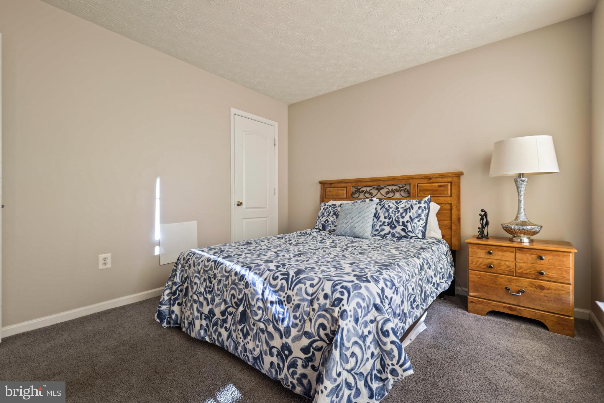 9716 Penguin Place Upper Marlboro, MD 20772 - Photo 28 of 84 a bedroom with a bed and a lamp
