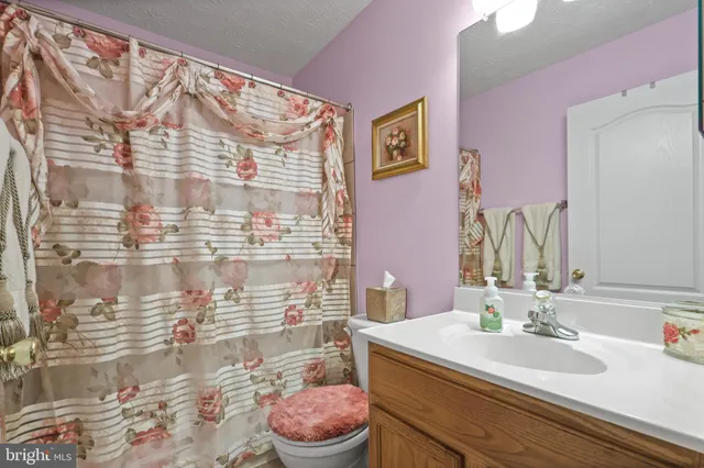 a living room with furniture a fireplace and a large window