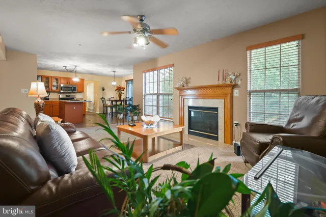 a living room with furniture and a large mirror on the table