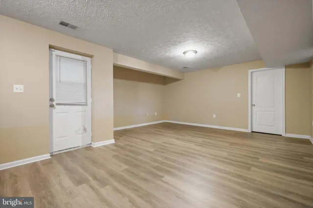 a living room with furniture stairs and a ceiling fan
