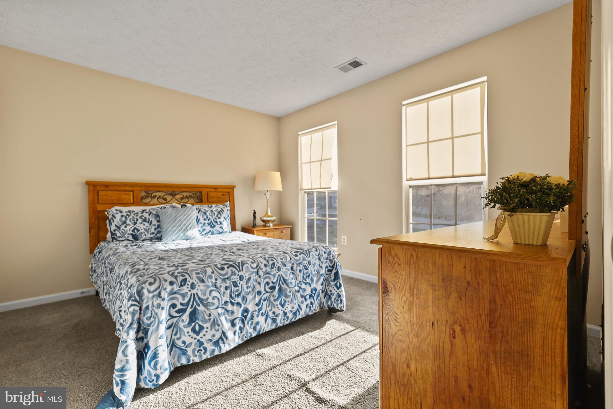 9716 Penguin Place Upper Marlboro, MD 20772 - Photo 4 of 84 a bedroom with a bed and wooden floor