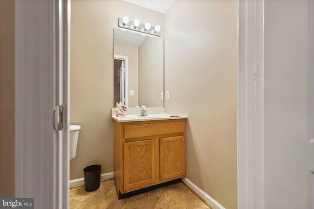 a large kitchen with stainless steel appliances granite countertop a stove refrigerator and a sink