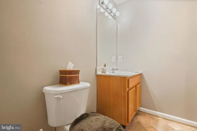 a kitchen with stainless steel appliances granite countertop a sink a counter space and a view of living room