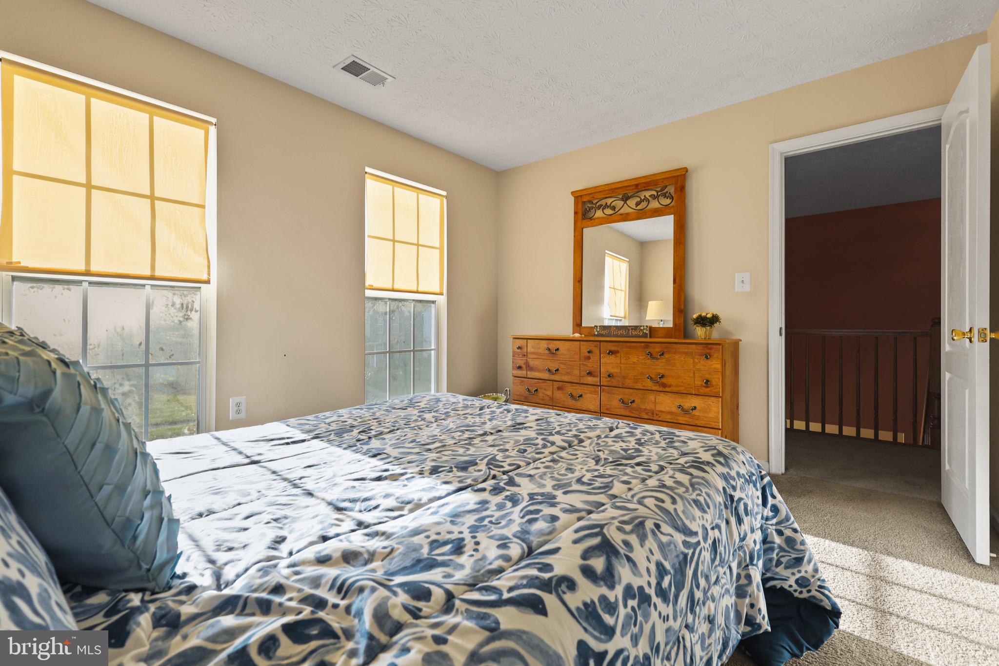 9716 Penguin Place Upper Marlboro, MD 20772 - Photo 5 of 84 a bedroom with a bed and a dresser