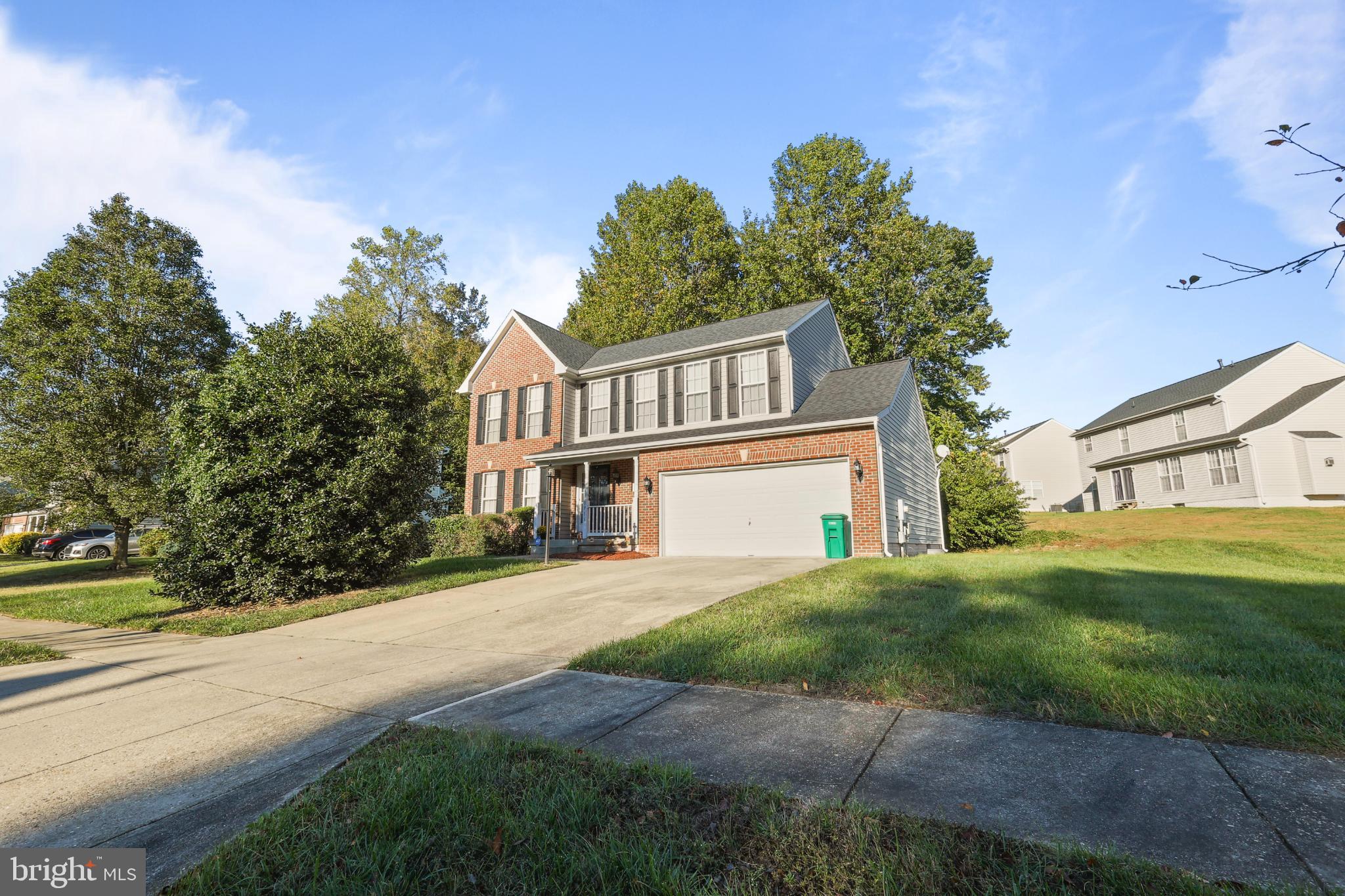9716 Penguin Place Upper Marlboro, MD 20772 - Photo 59 of 84 a front view of a house with a yard and garage