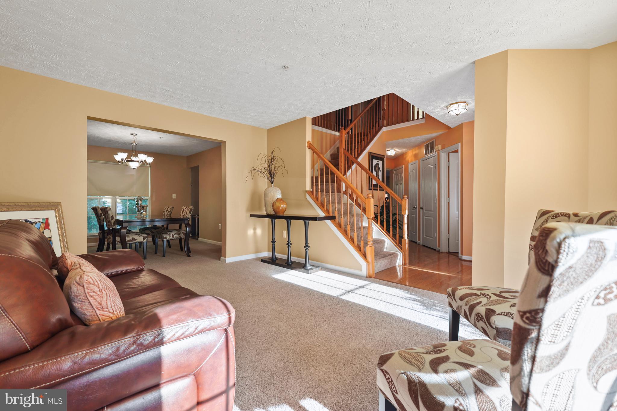 9716 Penguin Place Upper Marlboro, MD 20772 - Photo 70 of 84 a living room with furniture stairs and a ceiling fan
