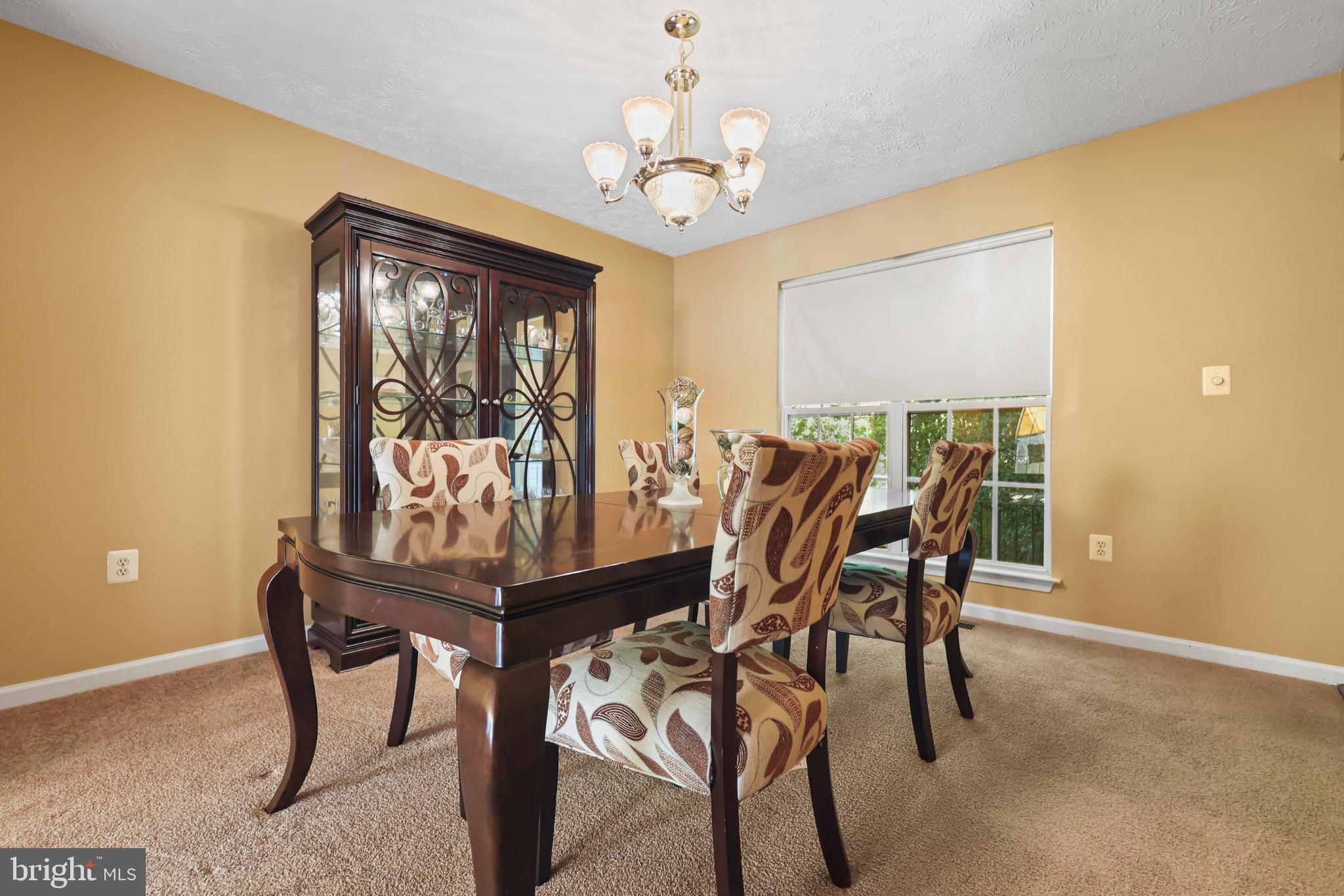 9716 Penguin Place Upper Marlboro, MD 20772 - Photo 72 of 84 a view of a dining room with furniture and a chandelier