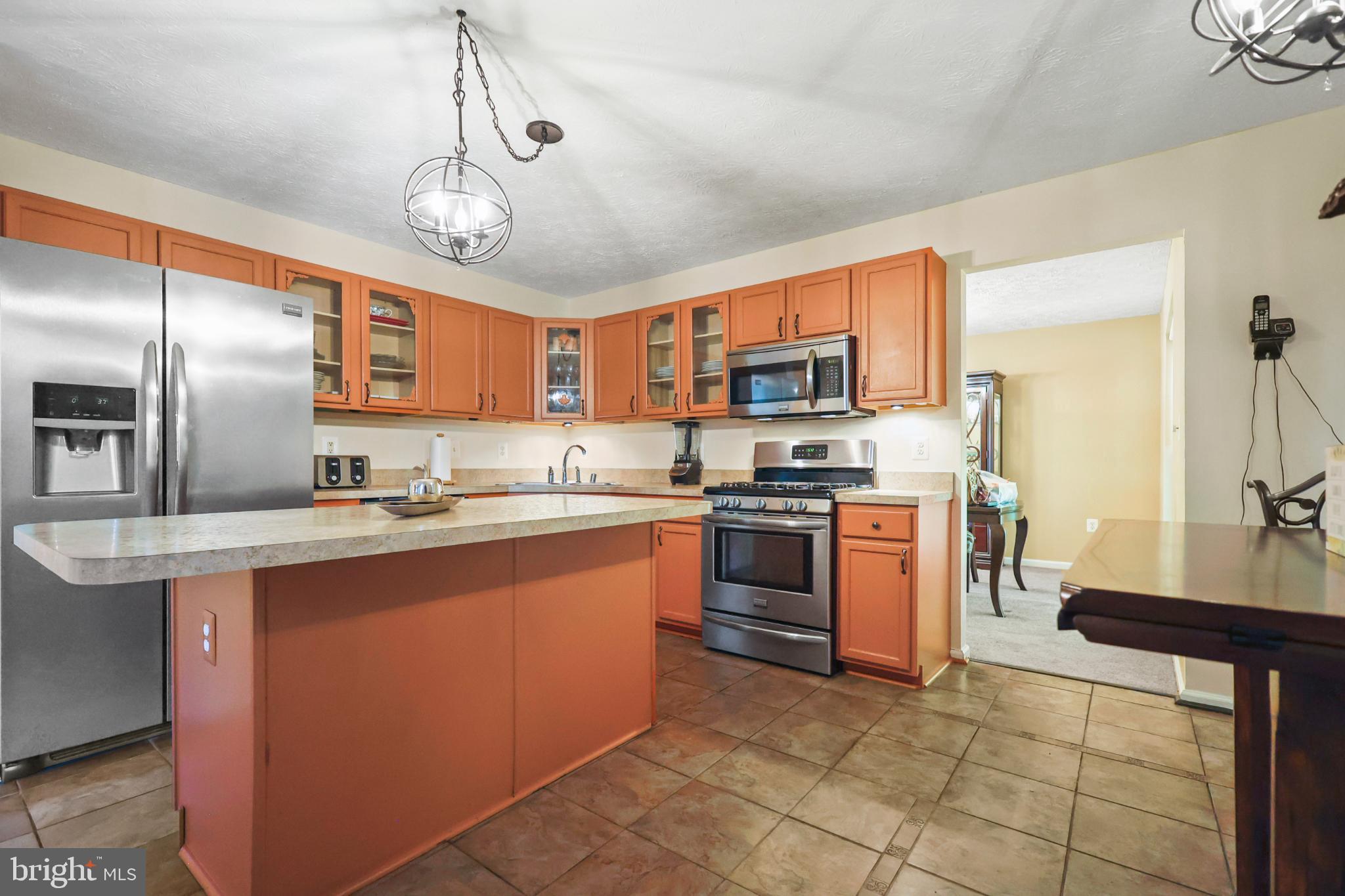 9716 Penguin Place Upper Marlboro, MD 20772 - Photo 77 of 84 a large kitchen with stainless steel appliances granite countertop a stove refrigerator and a sink