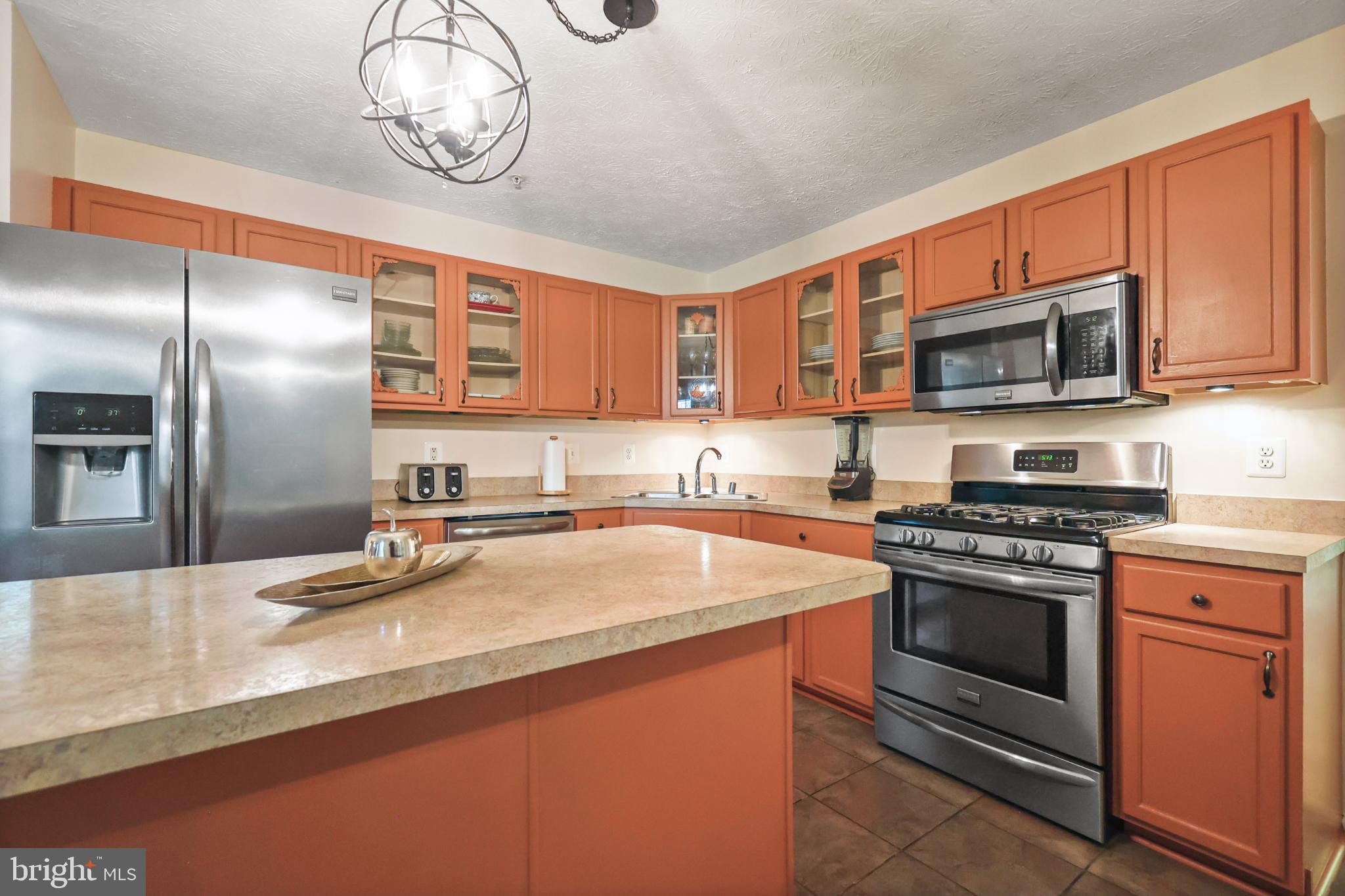 9716 Penguin Place Upper Marlboro, MD 20772 - Photo 78 of 84 a kitchen with stainless steel appliances granite countertop a stove microwave and cabinets