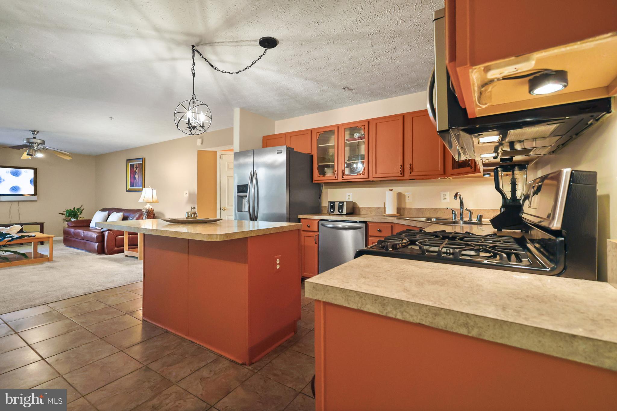9716 Penguin Place Upper Marlboro, MD 20772 - Photo 79 of 84 a kitchen with stainless steel appliances granite countertop a sink a counter space and a view of living room