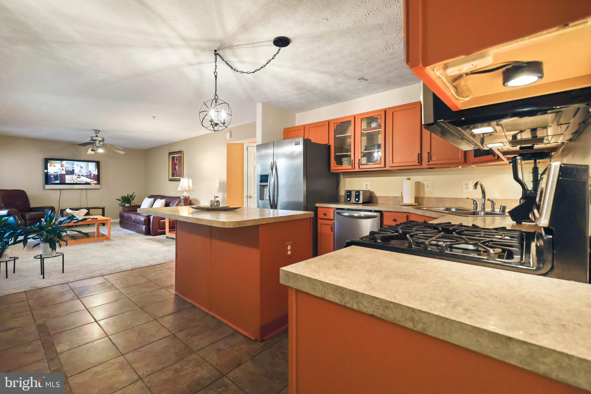9716 Penguin Place Upper Marlboro, MD 20772 - Photo 80 of 84 a kitchen with stainless steel appliances granite countertop a sink counter space and a living room view