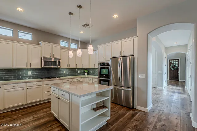 a living room with furniture a flat screen tv and a large window