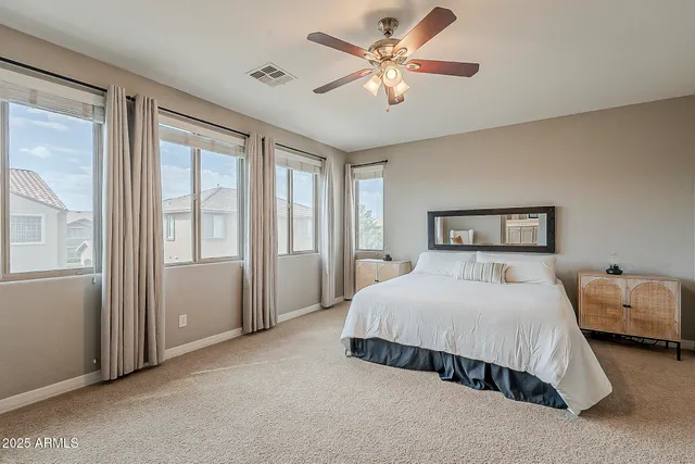 a bedroom with bed and balcony view