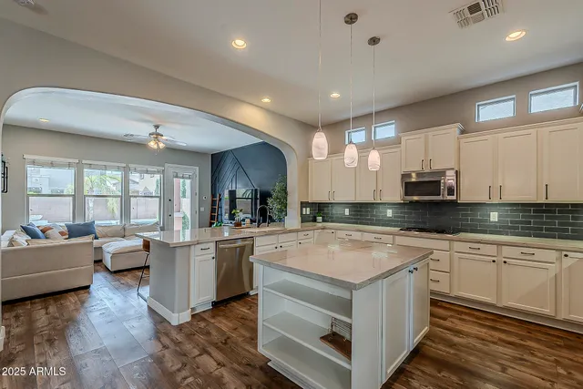 a living room with furniture and a view of kitchen