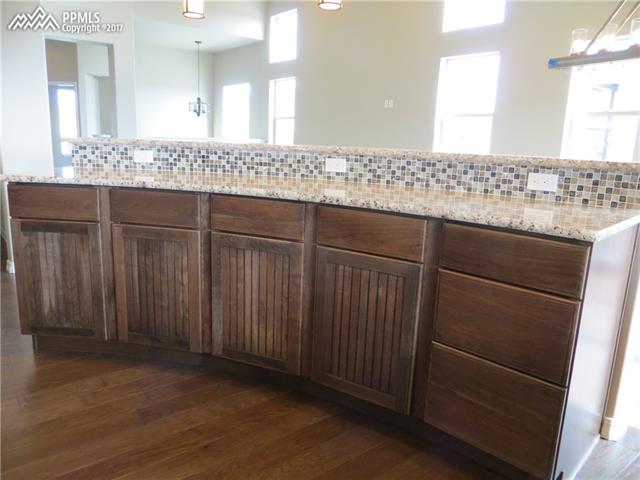 10604 Slumber Ridge Way Colorado Springs, CO 80908 - Photo 8 of 36 Huge Island with additional seating and cabinetry!