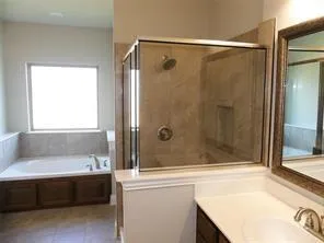 a bathroom with a shower and a bathtub