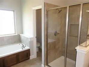 a bathroom with a bathtub and a shower