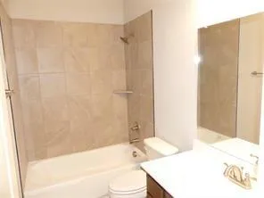 a bathroom with a sink a toilet and bathtub