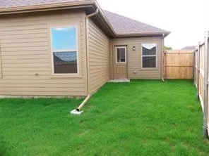 a view of a backyard of the house