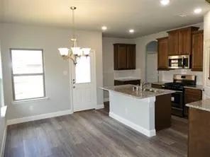 a kitchen with a sink stove and cabinets