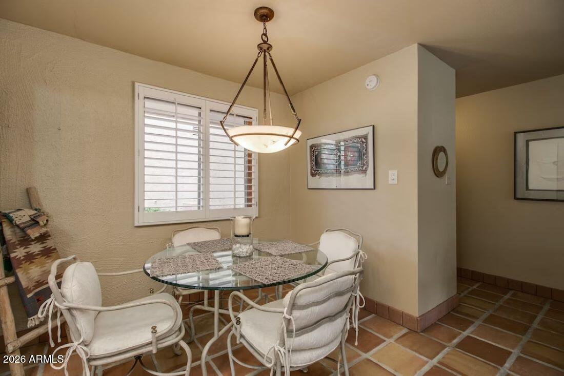 7625 East Camelback Road, Unit B117 Scottsdale, AZ 85251 - Photo 11 of 27 a dining room with furniture and window